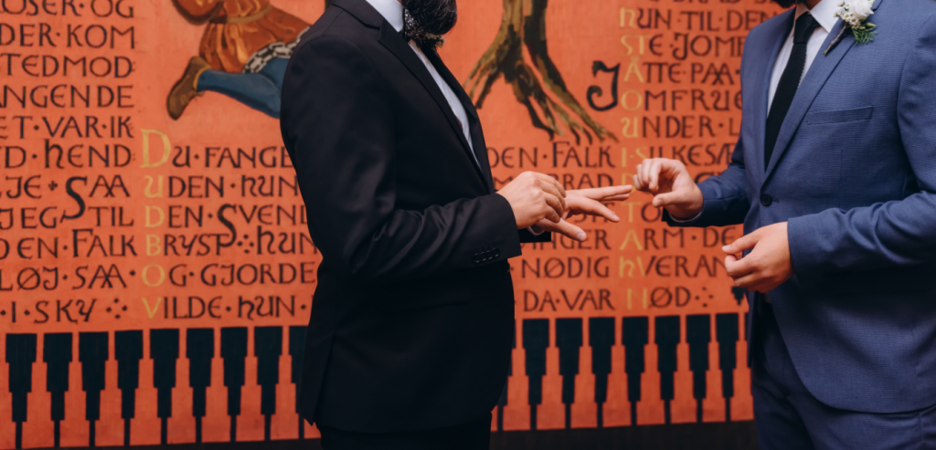 Two men in suits are getting married